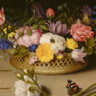 An oil painting of a basket full of flowers, with leaf cuttings interspersed throughout. The flowers are in shades of pink, blue, yellow, purple, orange, and white. There are three flowers which are on the table in front of the basket. One is a frilly pink rose, another is a white rose, and the third is a yellow tulip striped with orange lines. On top of the tulip is a black butterfly, and there is a dragonfly to the left of the white rose.