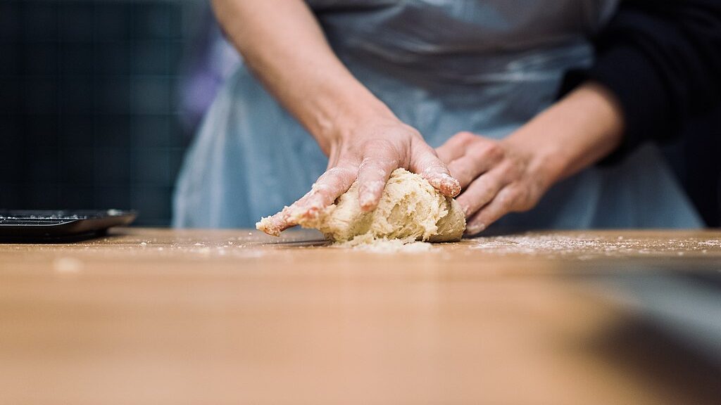 kneading dough on a counter