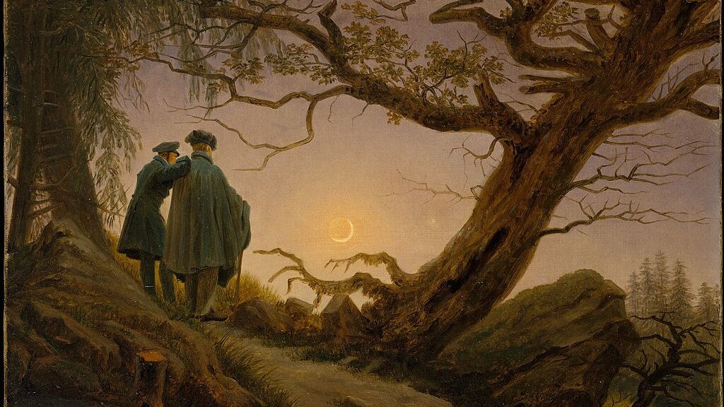 Two men standing side by side, viewing a crescent moon in the frame of a large tree.